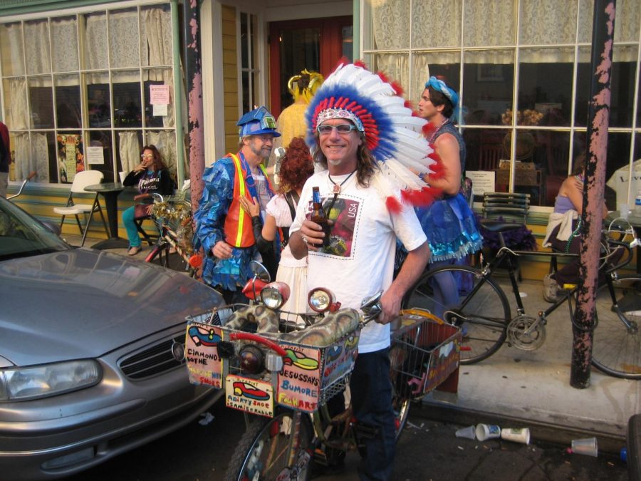 A non-Native American man dresses in a feather headdress for the purpose of selling goods, which does is exploitative of Native culture.