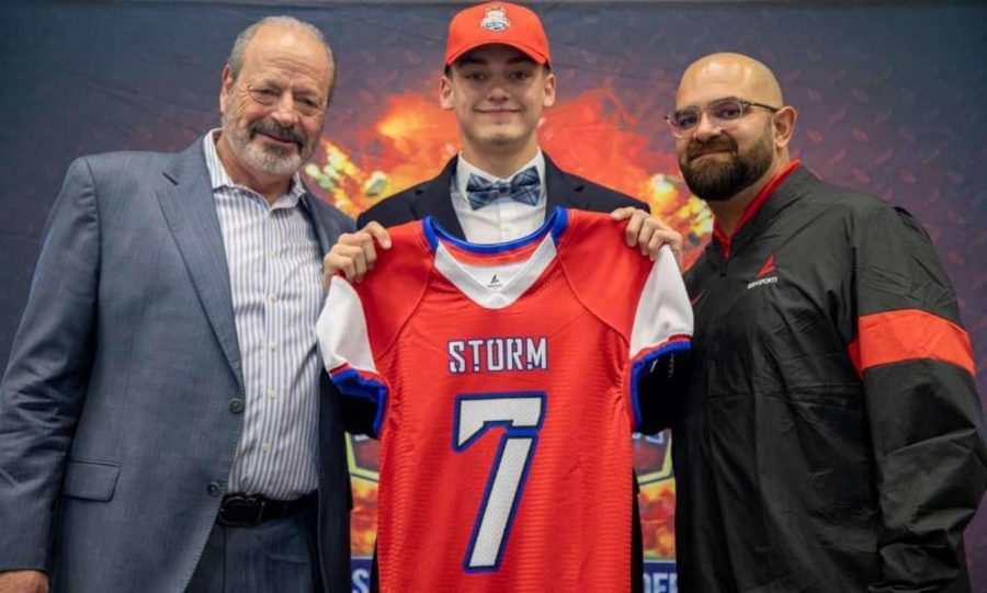 Davis Burns poses with former mayor Oscar Leeser and Joseph Vasquez of BSN Sports after being selected in the draft.