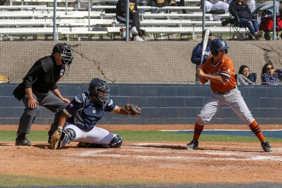 Millan receives a pitch while catching in a tournament game against Riverside.