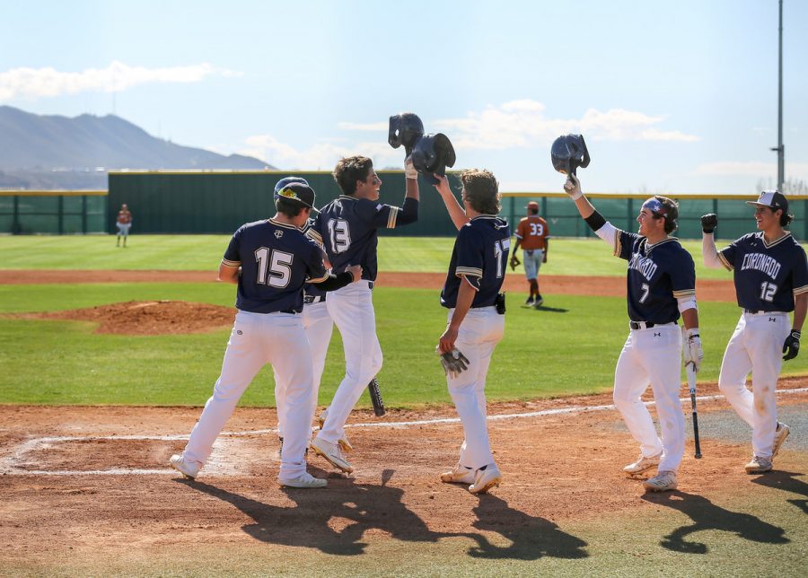 Team celebrates with senior Jorge Cuevas after he hits homerun earlier this year, prior to the canceling of the season.
