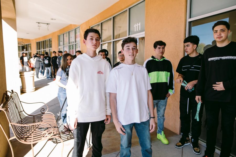 Drew (right) and Jamie Frank (left) stand in front of their store, Kickpin, which has a line of excited customers waiting to start shopping.