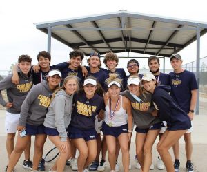 Members of the tennis team celebrate after finishing their district matches.
